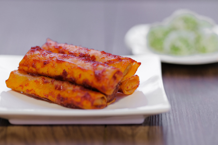 The Populous Fried Spicy popiah is spicy and crunchy in malay language is "Popia Sira Sambal" and Malay traditional delicacy,  called buah melaka on wooden table