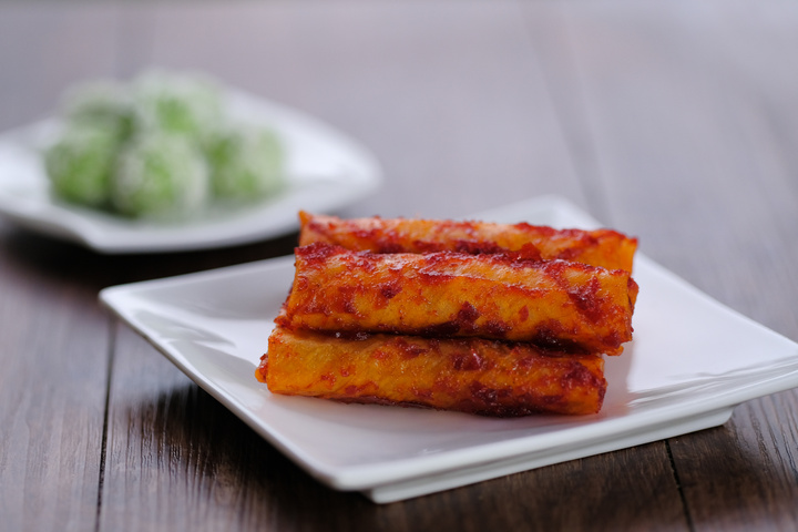 The Populous Fried Spicy popiah is spicy and crunchy in malay language is "Popia Sira Sambal" and Malay traditional delicacy,  called buah melaka on wooden table